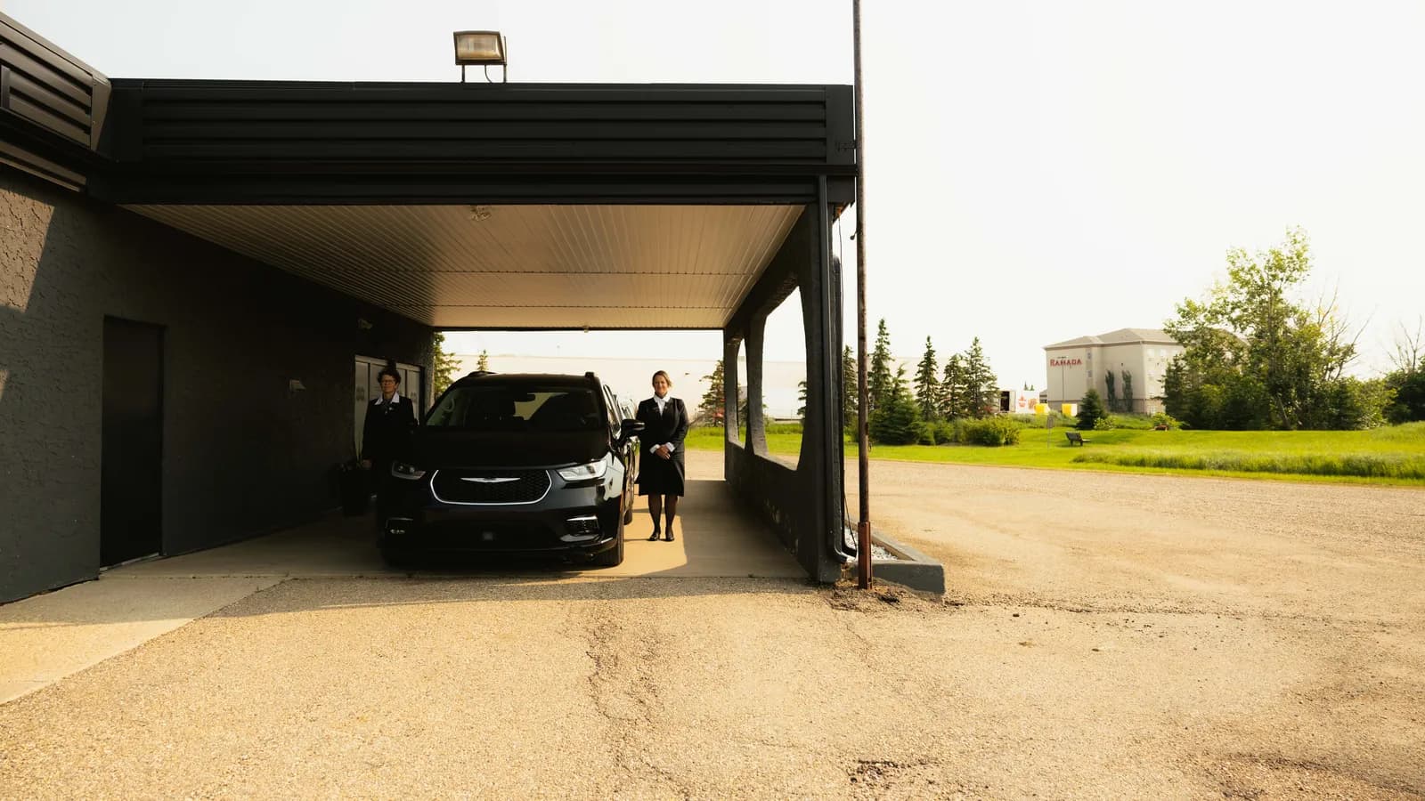 A couple sharing a quiet, supportive moment together in front of a cremation memorial, reflecting the compassionate care provided at Parkview Stettler.